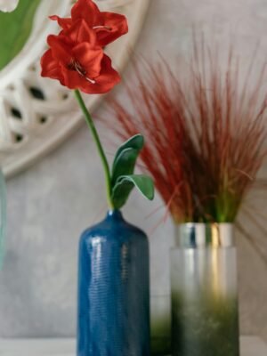 Decorative Blue Bottle Vase with Red Flower Accent